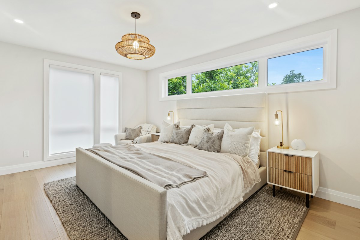 Bright bedroom with a freshly made bed